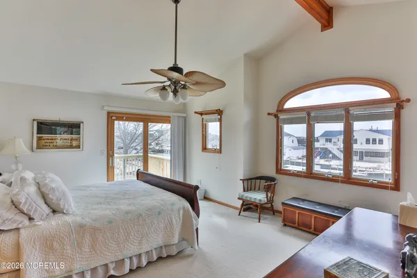 a bedroom with a large bed and a chandelier
