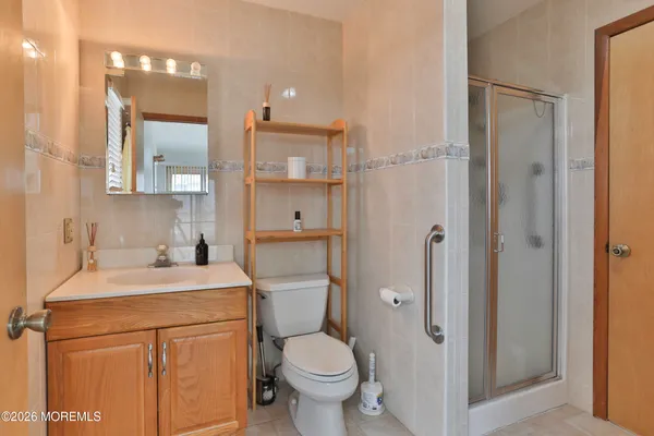 a bathroom with a sink toilet vanity and shower