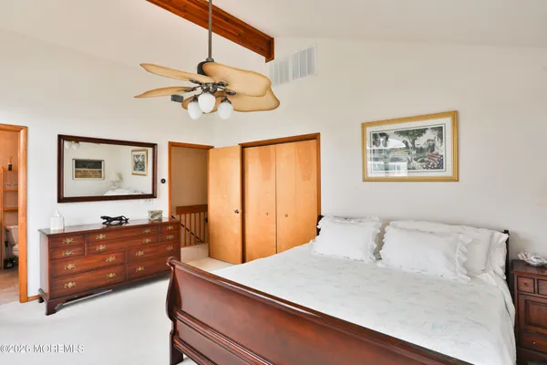 a bedroom with a bed and a dresser