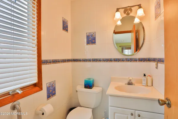 a bathroom with a sink mirror and toilet