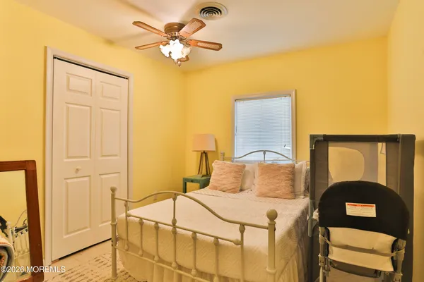 a bedroom with a bed and a painting on the wall