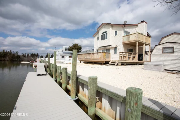 a front view of a house with yard and ocean view