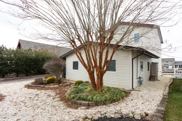 a backyard of a house with a garden and trees