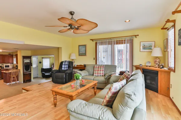 a living room with furniture a fireplace and a chandelier