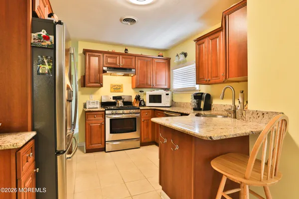 a kitchen with a stove a sink and a refrigerator