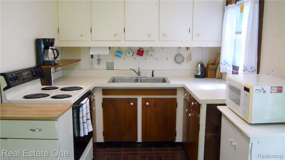 9639 Currie Road Northville, MI 48167 - Photo 23 of 24 KITCHEN WITH BRICK TILE FLOORING