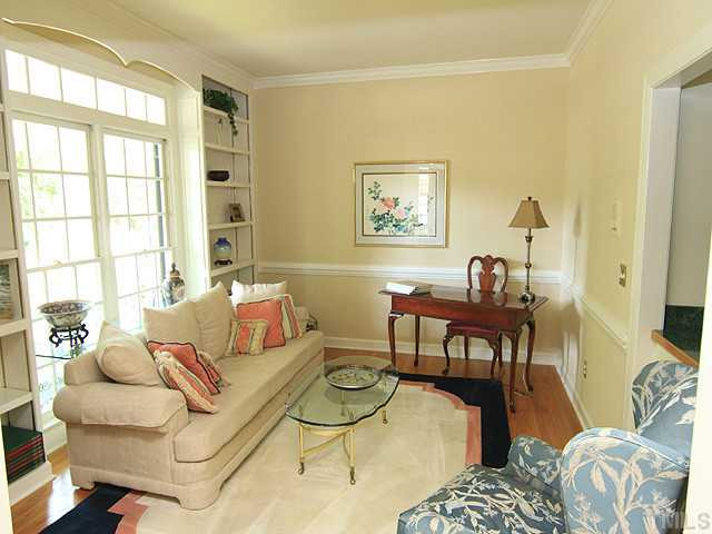 The formal living room has extensive moulding, built -ins and a built in bar. This custom built home has it all and provides the perfect flow for entertaining. Living Room