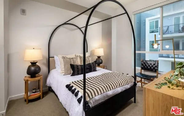 a bedroom with bed and a potted plant