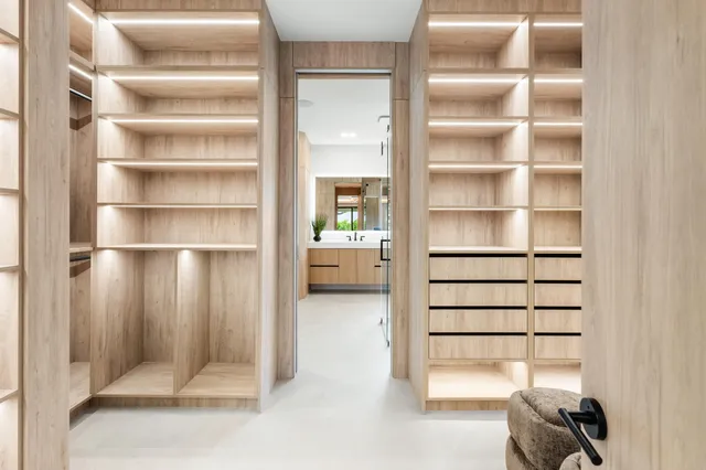 a living room with large windows and a table