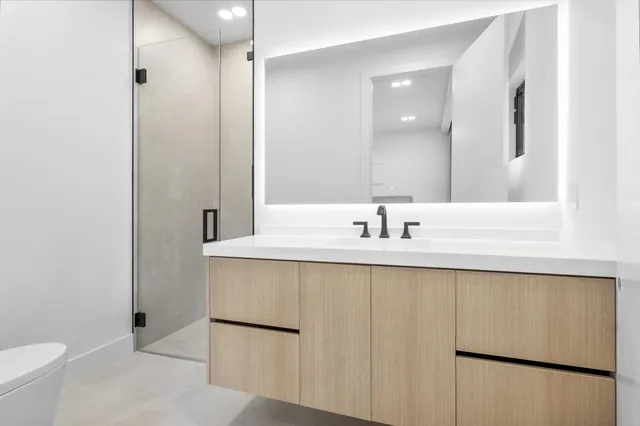 an aerial view of residential houses with outdoor space and street view