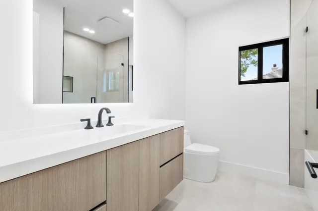 a front view of a house with a garden and yard