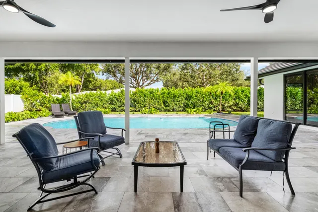 swimming pool view with a seating space
