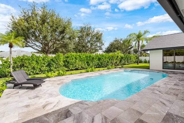 a view of a swimming pool with an outdoor seating