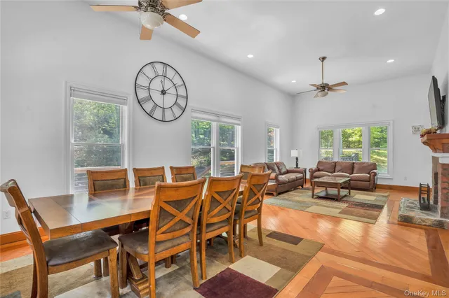 a living room with furniture a clock and a large window