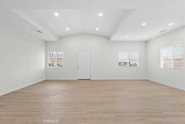 an empty room with windows and entrance