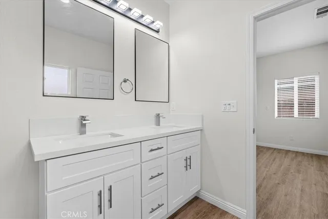 a bathroom with 2 sink and a mirror