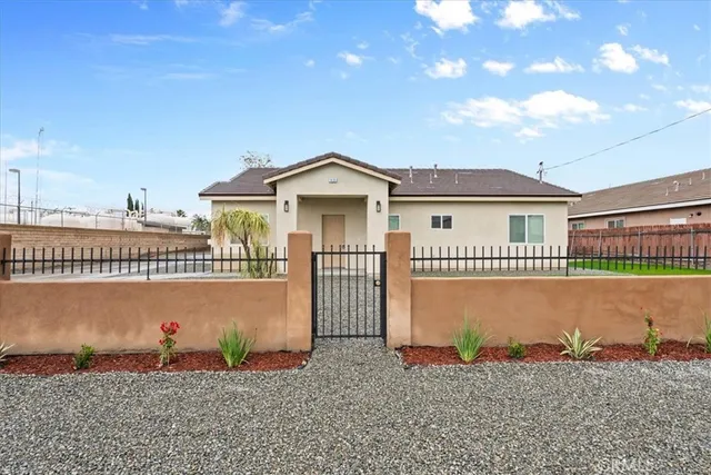 a front view of a house with a garden
