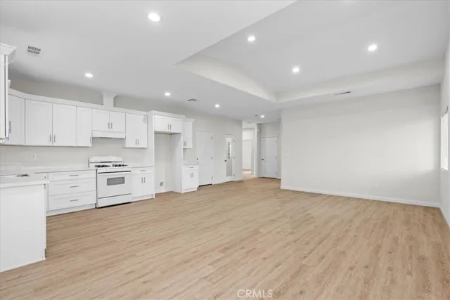 a view of kitchen with wooden floor and electronic appliances