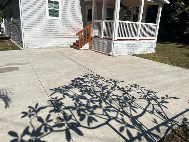 a view of a backyard with a tree