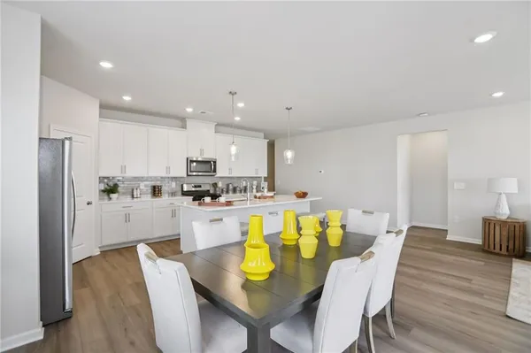 a large kitchen with a table and chairs