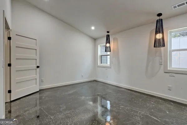 a kitchen with stainless steel appliances granite countertop a sink a stove and a refrigerator