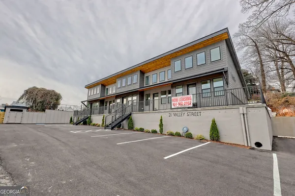a front view of a house with large windows