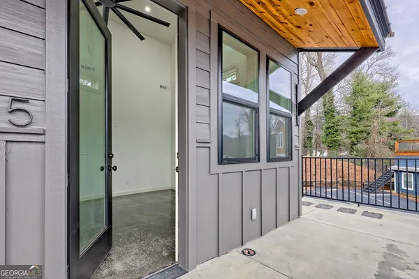 a view of a hallway with a livingroom and dining room