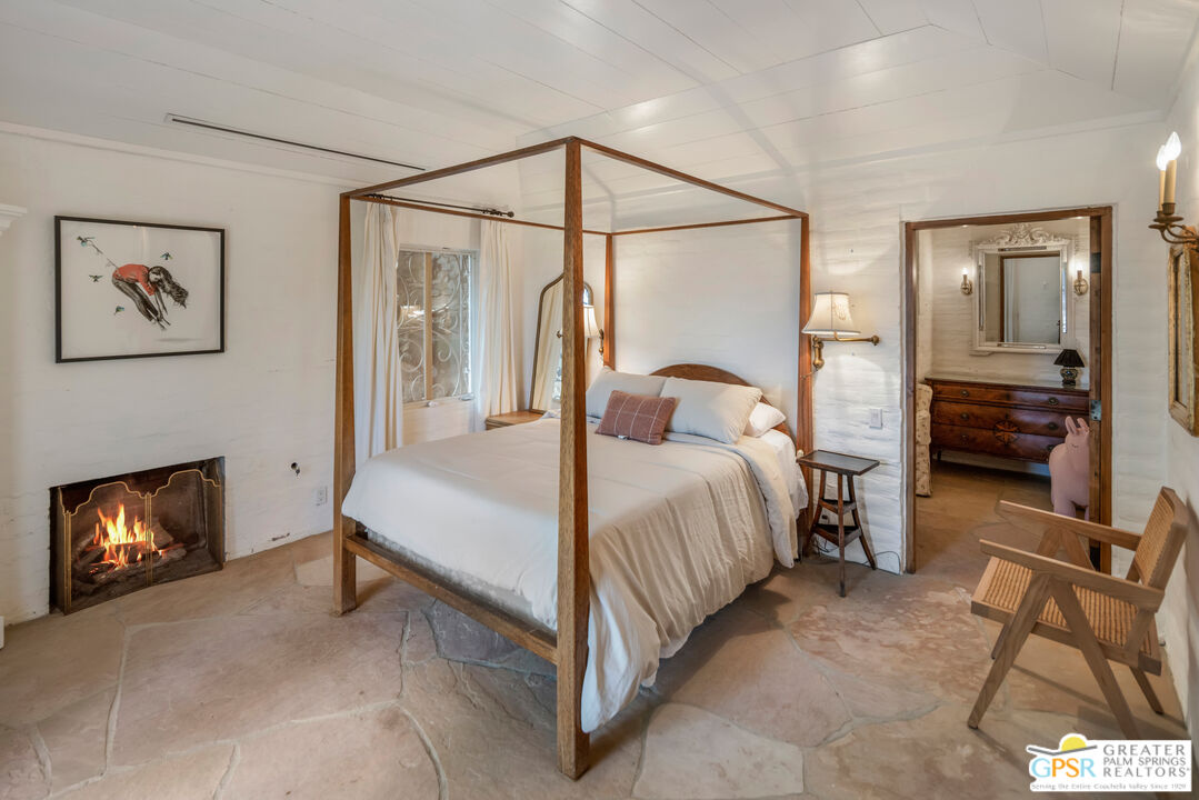 252 Ridge Road Palm Springs, CA 92264 - Photo 38 of 53 a bedroom with a bed and a fireplace