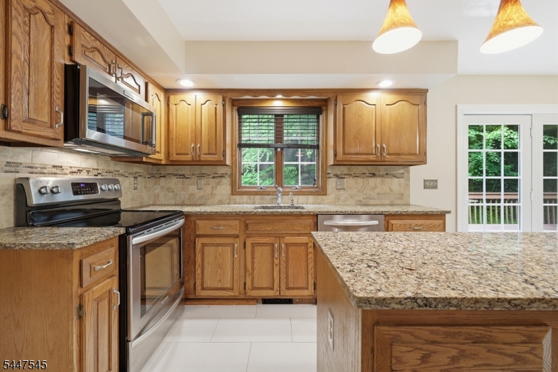860 Glen Road Sparta, NJ 07871 - Photo 8 of 43 a kitchen with stainless steel appliances granite countertop a sink stove and cabinets