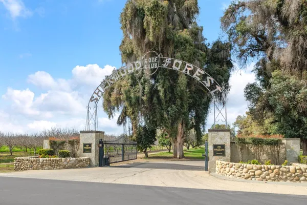 a view of a house with a yard and sitting area