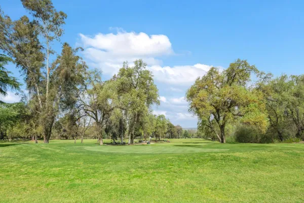 a large kitchen with kitchen island a sink a counter top space and stainless steel appliances