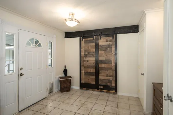 a view of a dining room with furniture and a chandelier