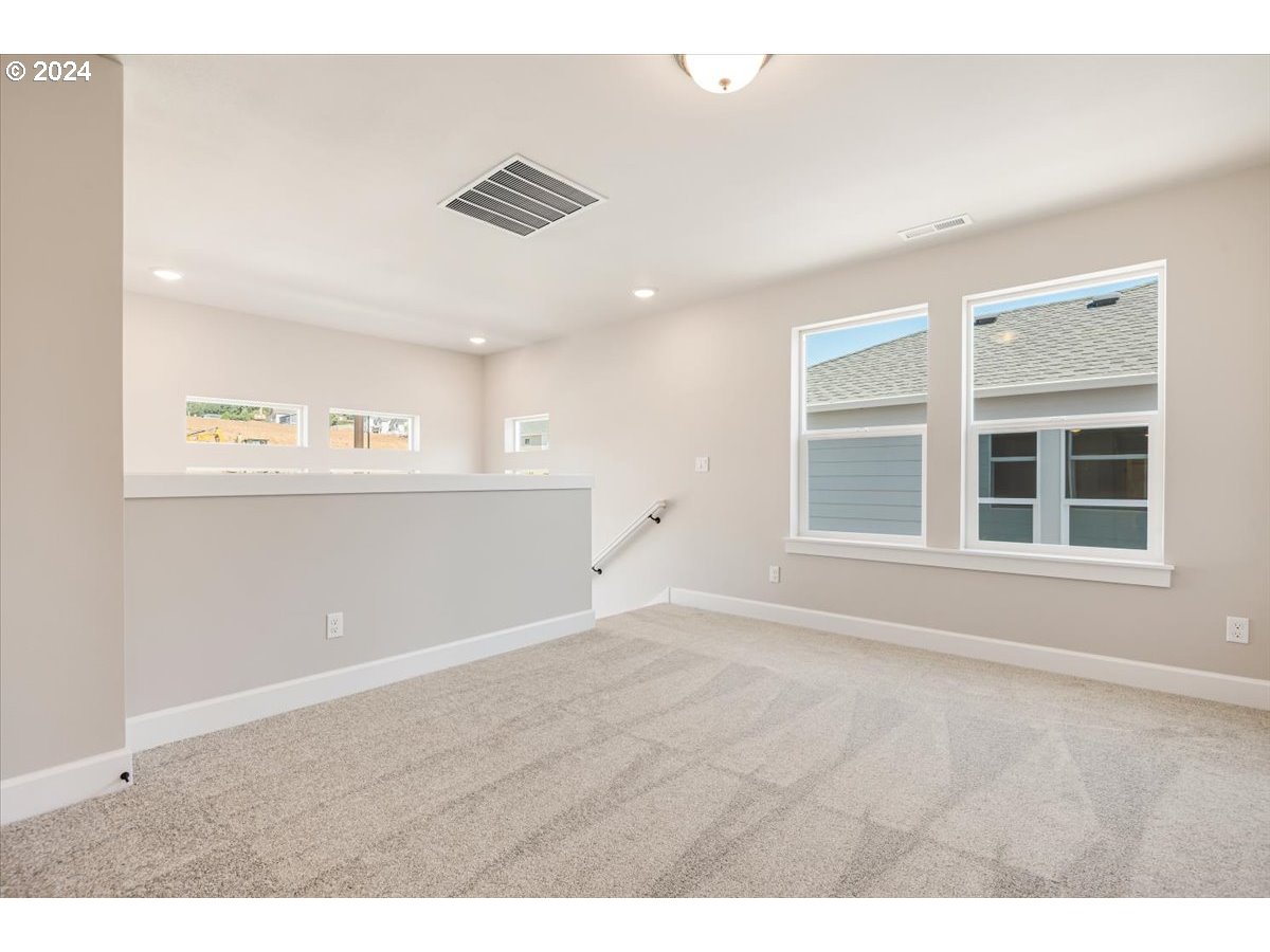 18050 Southwest Barrows Road Beaverton, OR 97007 - Photo 18 of 45 a view of an empty room with a window