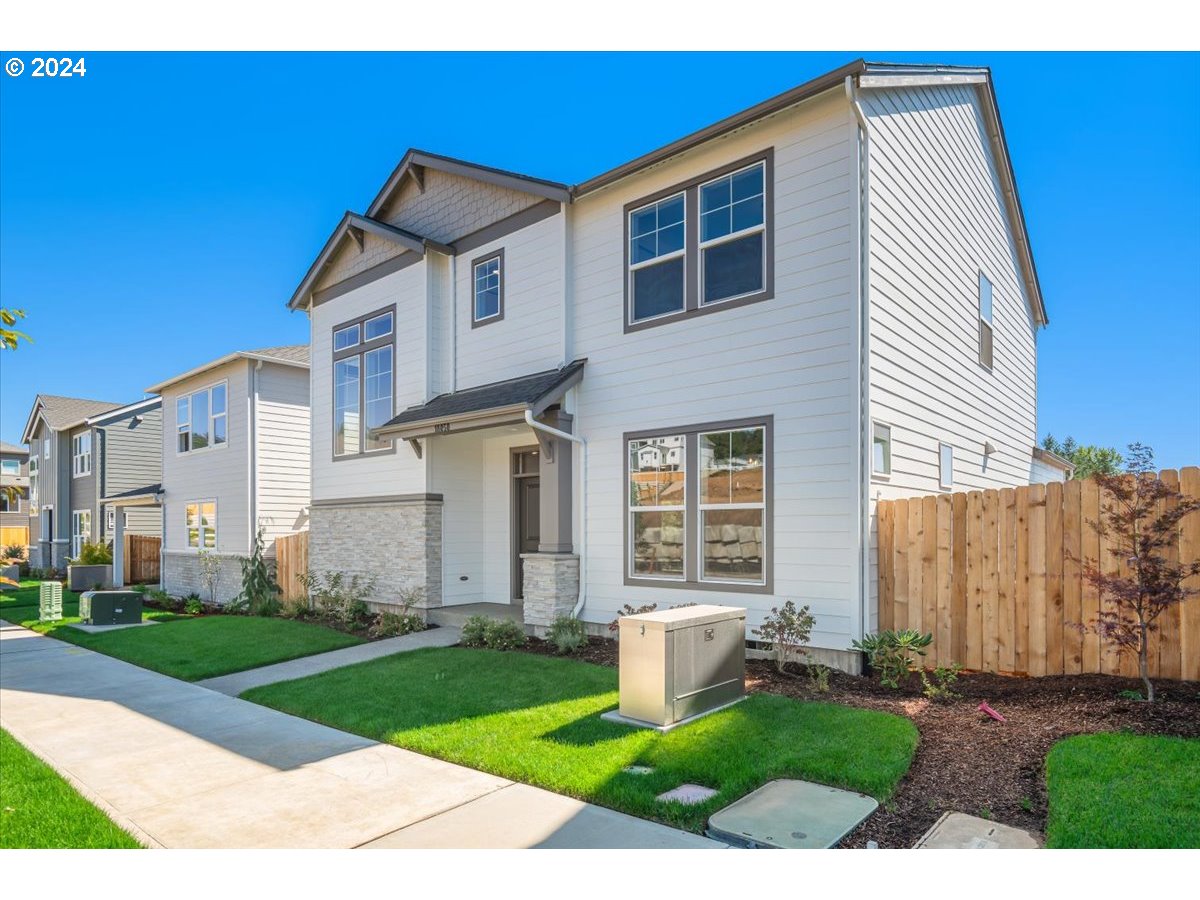 18050 Southwest Barrows Road Beaverton, OR 97007 - Photo 2 of 45 a front view of a house with a yard and garage