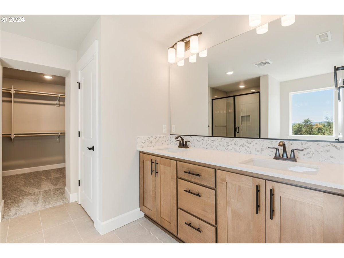 18050 Southwest Barrows Road Beaverton, OR 97007 - Photo 22 of 45 a bathroom with a double vanity sink and mirror