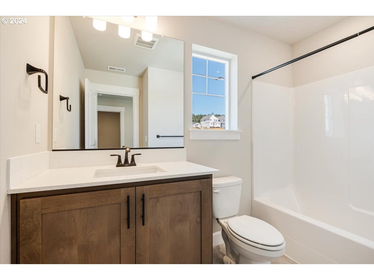 18050 Southwest Barrows Road Beaverton, OR 97007 - Photo 25 of 45 a bathroom with a granite countertop sink toilet and shower