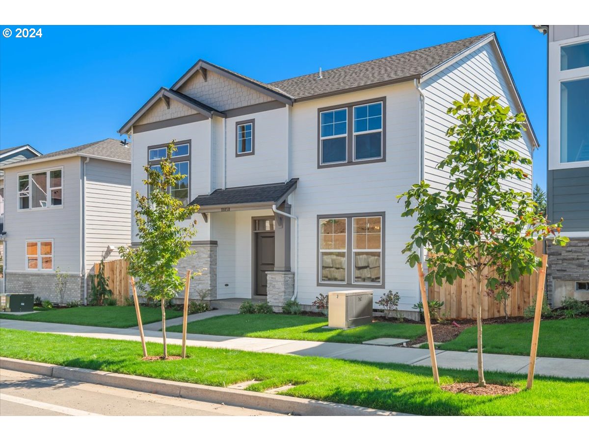 18050 Southwest Barrows Road Beaverton, OR 97007 - Photo 3 of 45 a front view of a house with a garden and plants