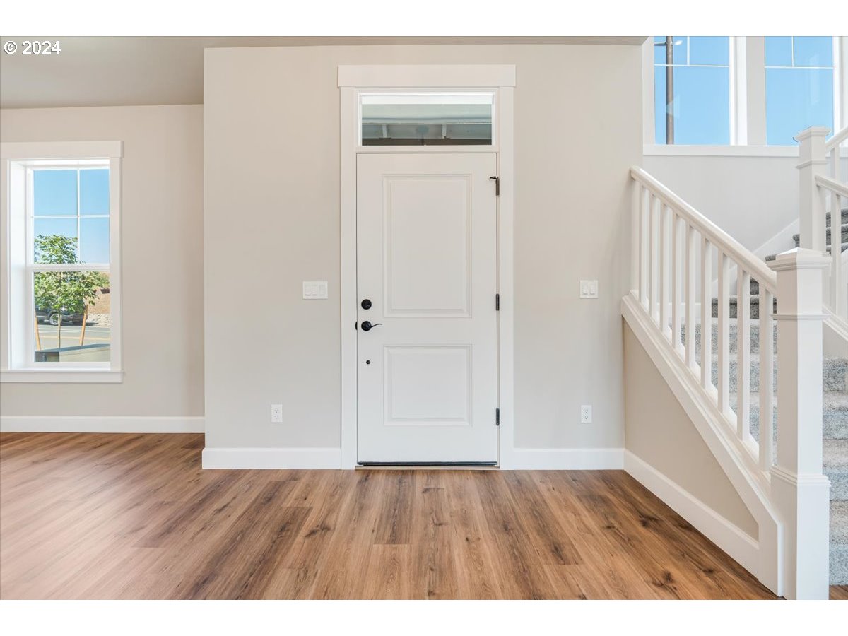 18050 Southwest Barrows Road Beaverton, OR 97007 - Photo 5 of 45 a view of an entryway with wooden floor