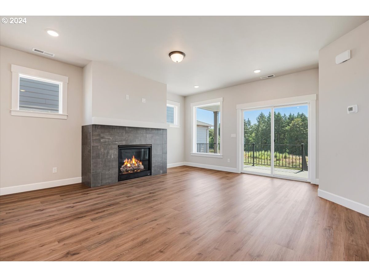 18050 Southwest Barrows Road Beaverton, OR 97007 - Photo 7 of 45 a view of an empty room with wooden floor and a window