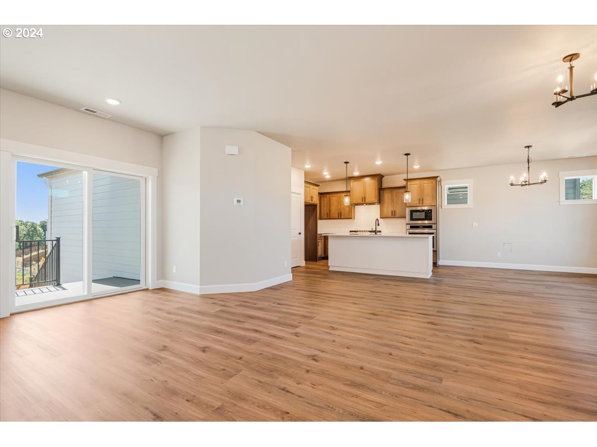 18050 Southwest Barrows Road Beaverton, OR 97007 - Photo 8 of 45 a view of a kitchen with a sink and a refrigerator