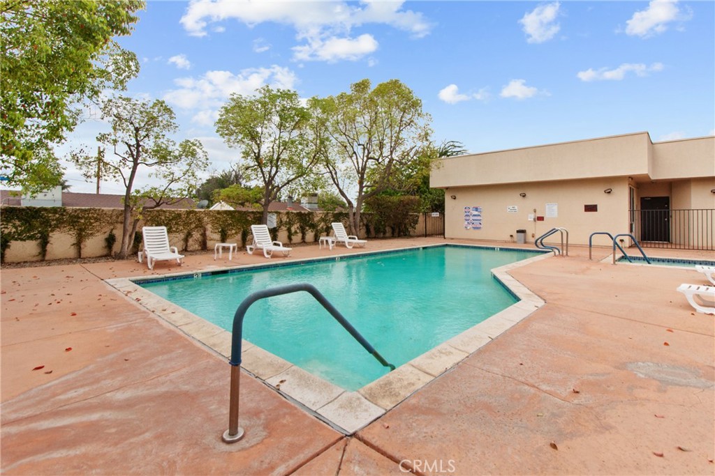 19350 Sherman Way, Unit 125 Reseda, CA 91335 - Photo 18 of 20 a view of a swimming pool with a patio and a yard