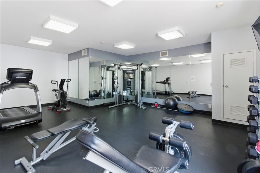 19350 Sherman Way, Unit 125 Reseda, CA 91335 - Photo 19 of 20 a gym room with lots of furniture and a wooden floor
