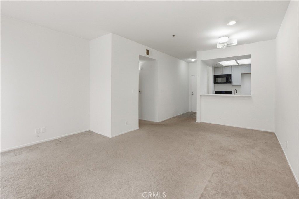 19350 Sherman Way, Unit 125 Reseda, CA 91335 - Photo 4 of 20 a view of a big room with closet and windows