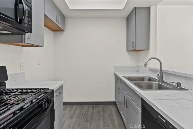 a kitchen with stainless steel appliances granite countertop a sink stove and cabinets