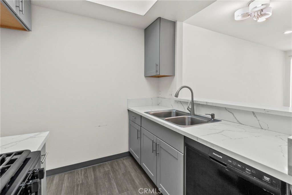 19350 Sherman Way, Unit 125 Reseda, CA 91335 - Photo 7 of 20 a kitchen with a sink and cabinets