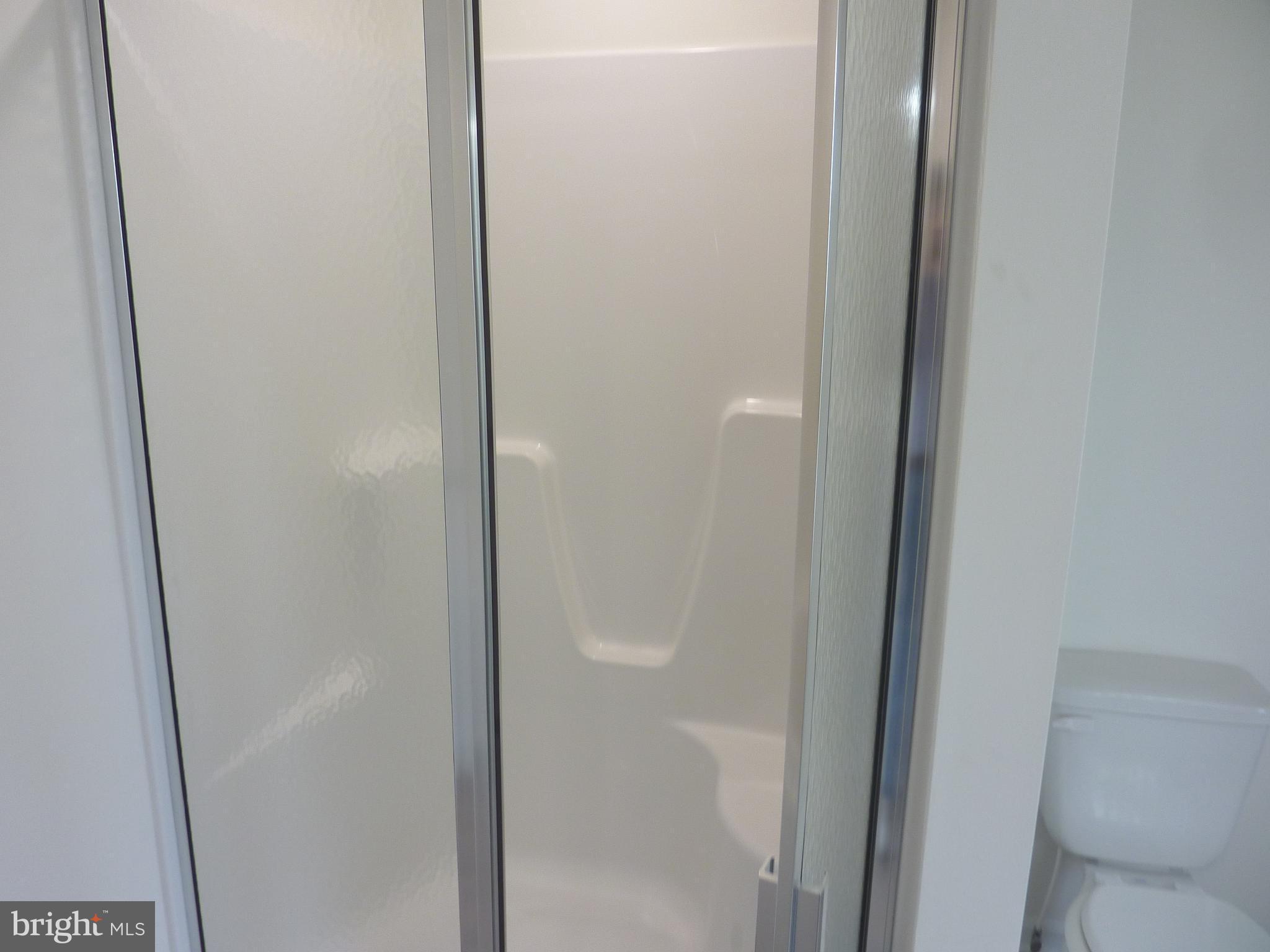 106 Parma Drive Clayton, DE 19938 - Photo 27 of 51 a bathroom with a glass shower door