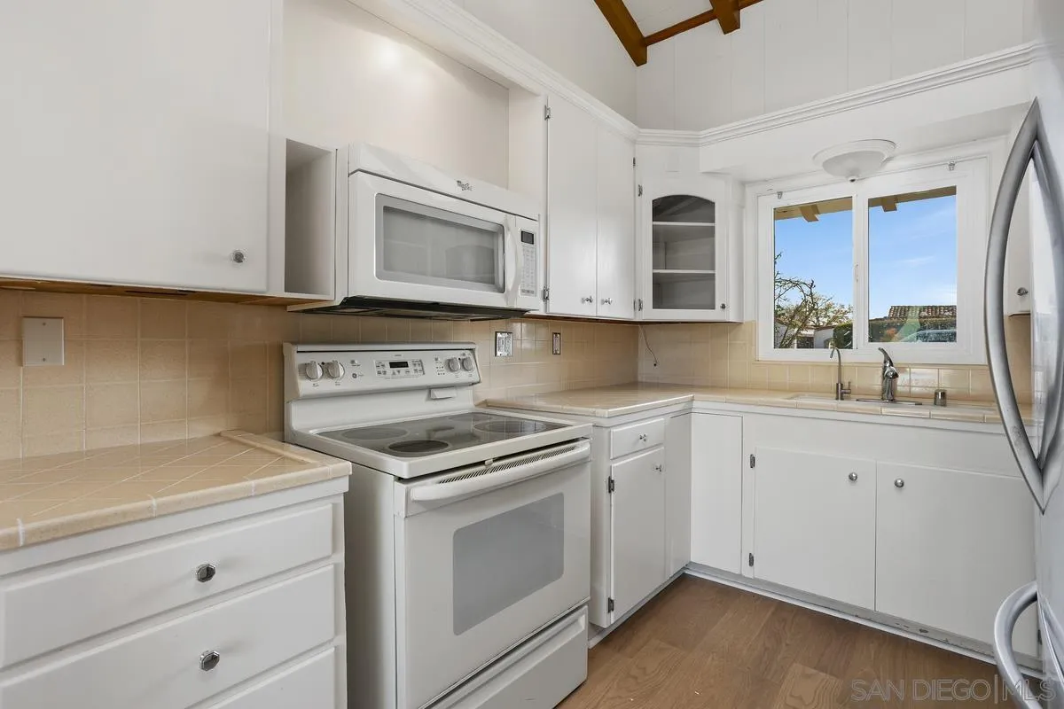 6138 La Flecha Rancho Santa Fe, CA 92067 - Photo 4 of 14 a kitchen with cabinets stainless steel appliances and a counter space