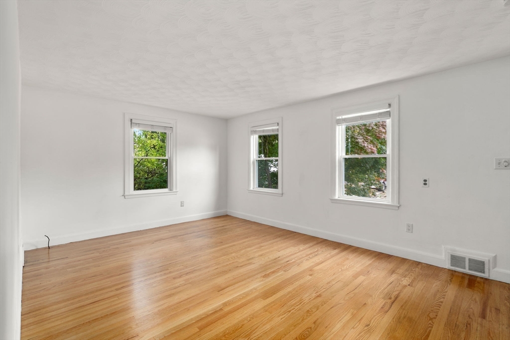 46 Bayard Street Dedham, MA 02026 - Photo 12 of 34 a view of an empty room with wooden floor and a window