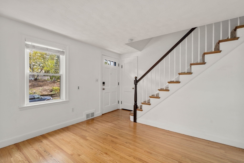 46 Bayard Street Dedham, MA 02026 - Photo 15 of 34 a view of an entryway with wooden floor and stairs
