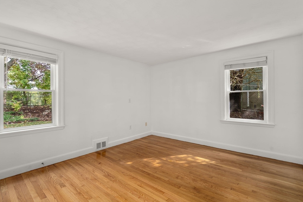 46 Bayard Street Dedham, MA 02026 - Photo 16 of 34 a view of an empty room with wooden floor and a window
